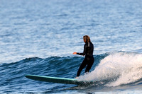Surfer girl/woman/gal Riding a Wave